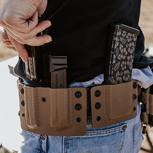 An image of a man using his double magazine holster at the range.